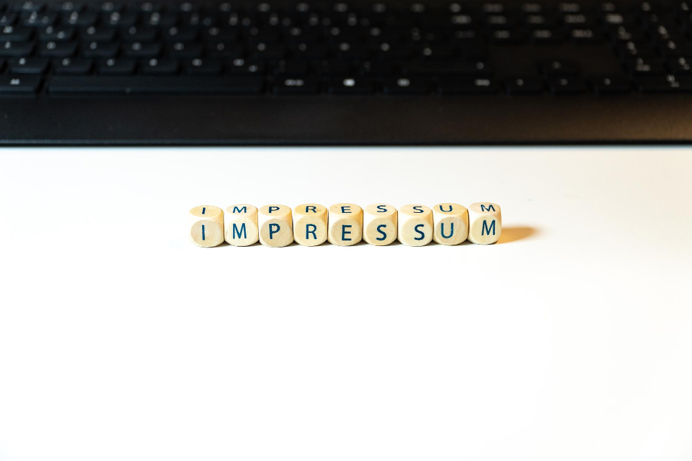 impressum Ausgelegte Buchstaben (Impressum) vor dem Computer